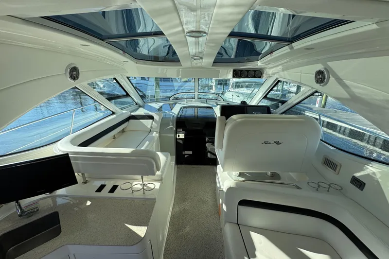 Slide: The Image of 2010 Sea Ray 470 Sundancer yacht docked, showcasing spacious deck and sleek design. - 3