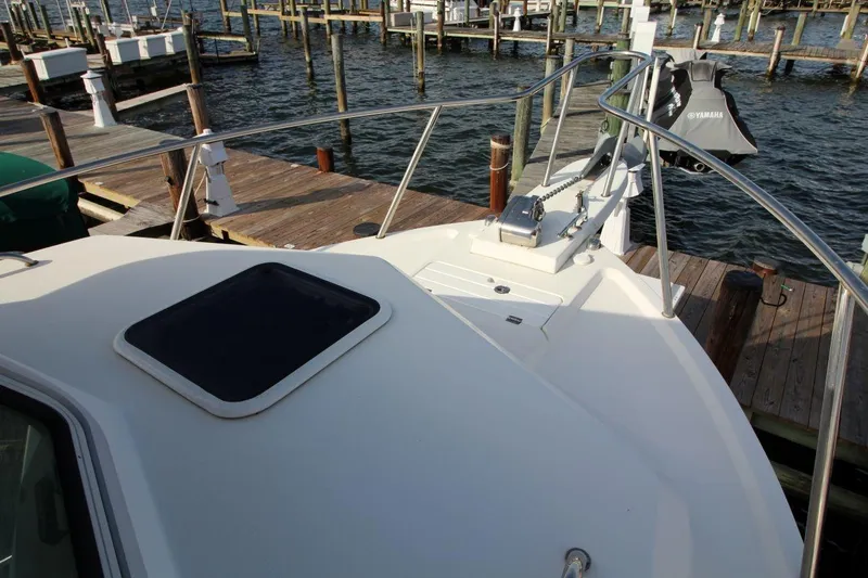 Slide: The Image of 2017 Parker 2820 XLD Sport Cabin boat docked, featuring deck and railing. - 11