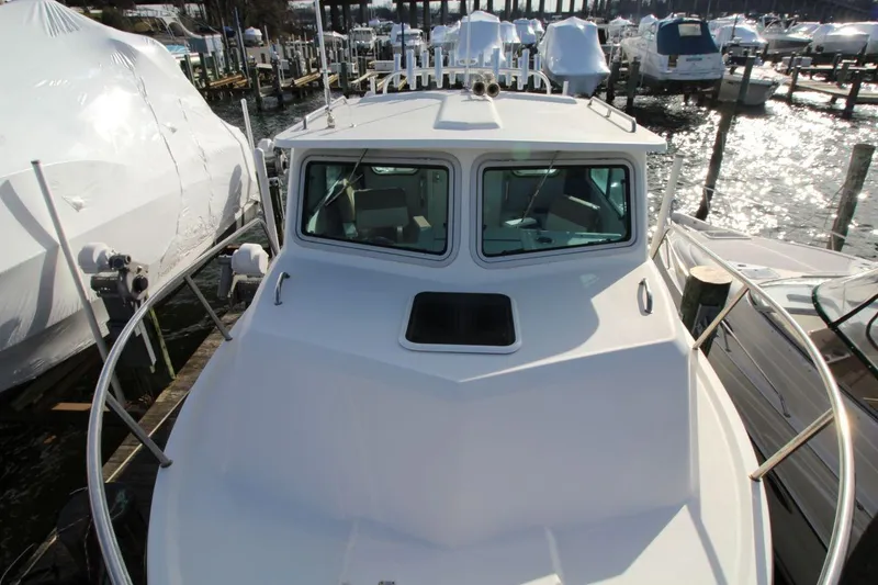 Slide: The Image of 2017 Parker 2820 XLD Sport Cabin boat docked at marina, front view. - 12