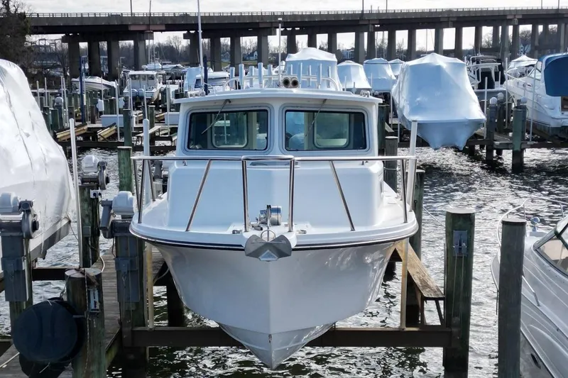 Slide: The Image of 2017 Parker 2820 XLD Sport Cabin boat docked at marina, front view. - 3