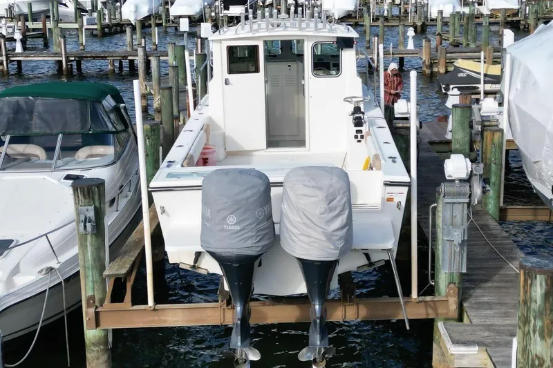 Slide: The Image of 2017 Parker 2820 XLD Sport Cabin boat docked with twin Yamaha engines. - 4