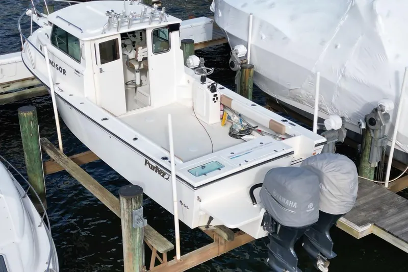 Slide: The Image of 2017 Parker 2820 XLD Sport Cabin boat docked with twin Yamaha engines. - 6