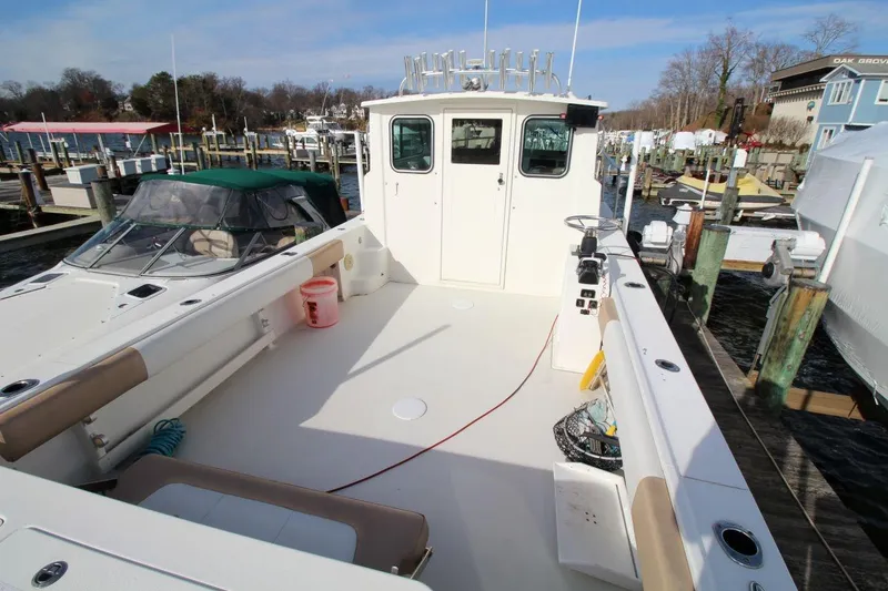 Slide: The Image of 2017 Parker 2820 XLD Sport Cabin boat docked at marina, spacious deck view. - 9