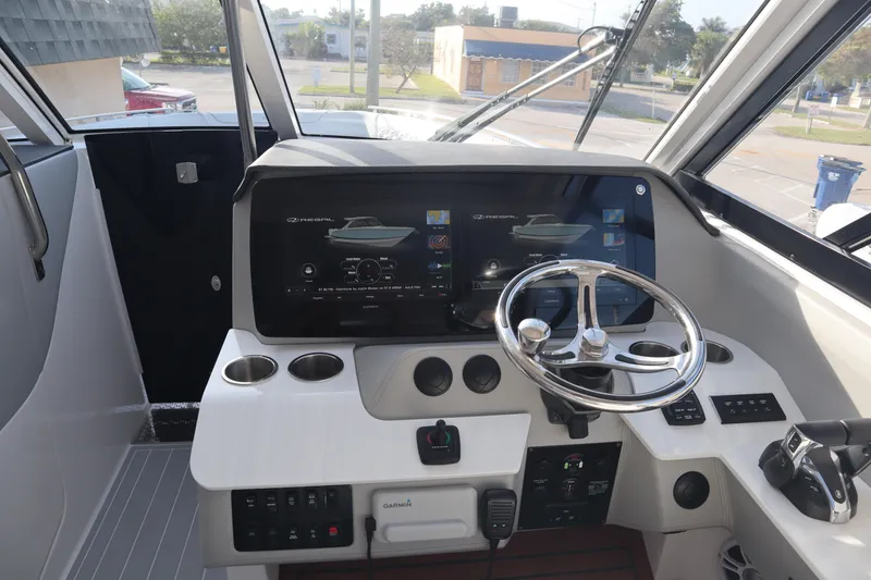 Slide: The Image of 2022 Regal LX36 boat helm with modern controls and navigation screens. - 11