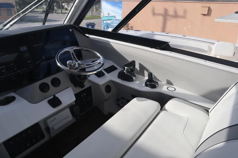 Slide: The Image of 2022 Regal LX36 boat cockpit with modern steering and controls. - 17
