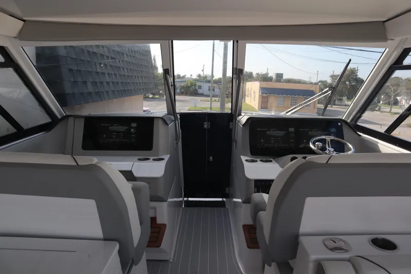 Slide: The Image of 2022 Regal LX36 boat cockpit with modern controls and dual seating. - 18
