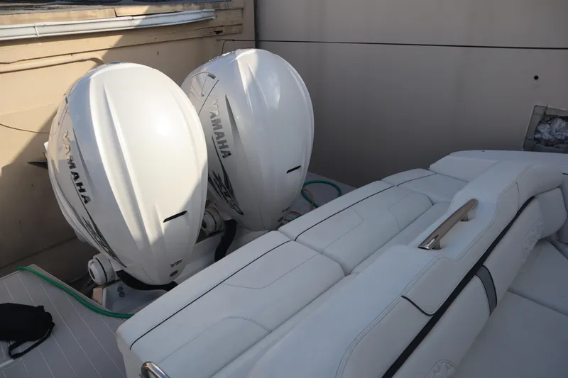 Slide: The Image of 2022 Regal LX36 boat with twin Yamaha outboard engines, featuring white leather seating. - 19