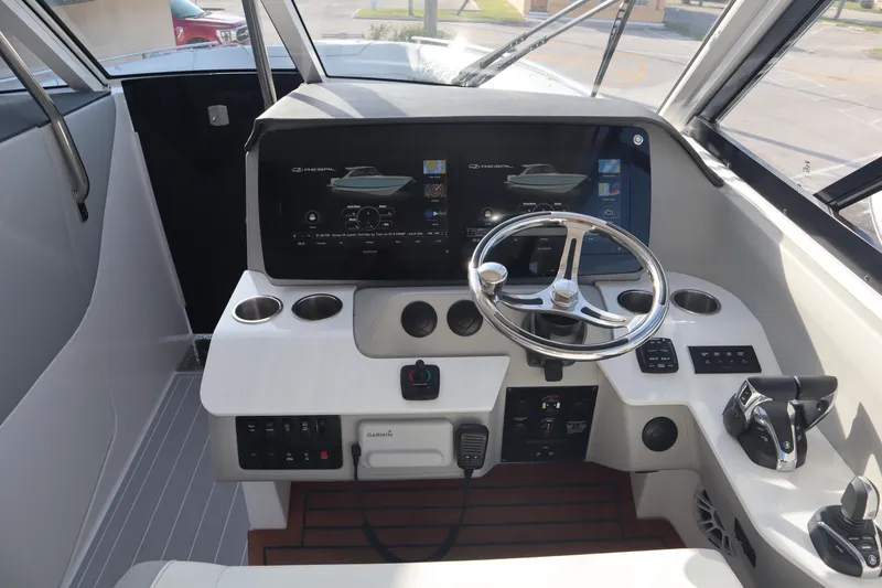 Slide: The Image of 2022 Regal LX36 boat cockpit with modern steering and control panel. - 24