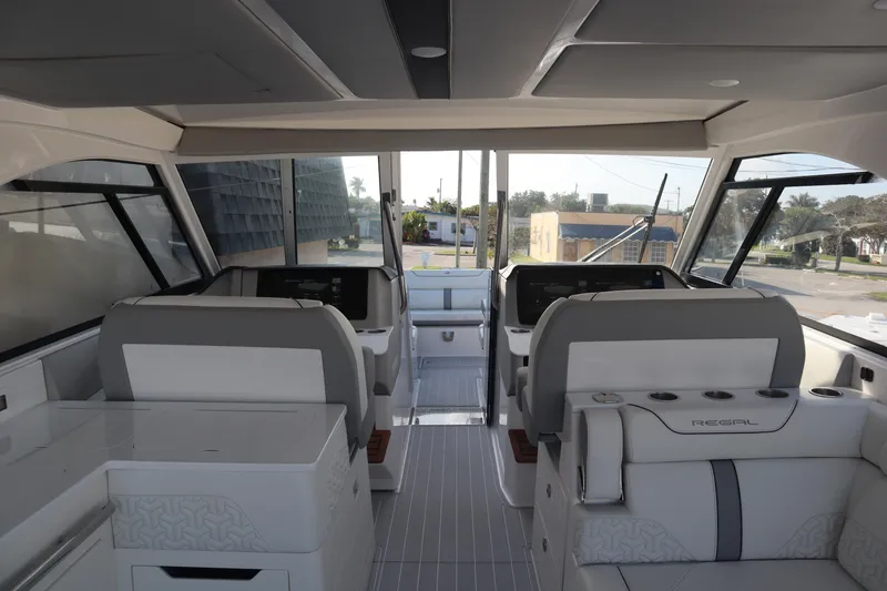 Slide: The Image of Interior of a 2022 Regal LX36 boat, featuring modern seating and dashboard. - 33