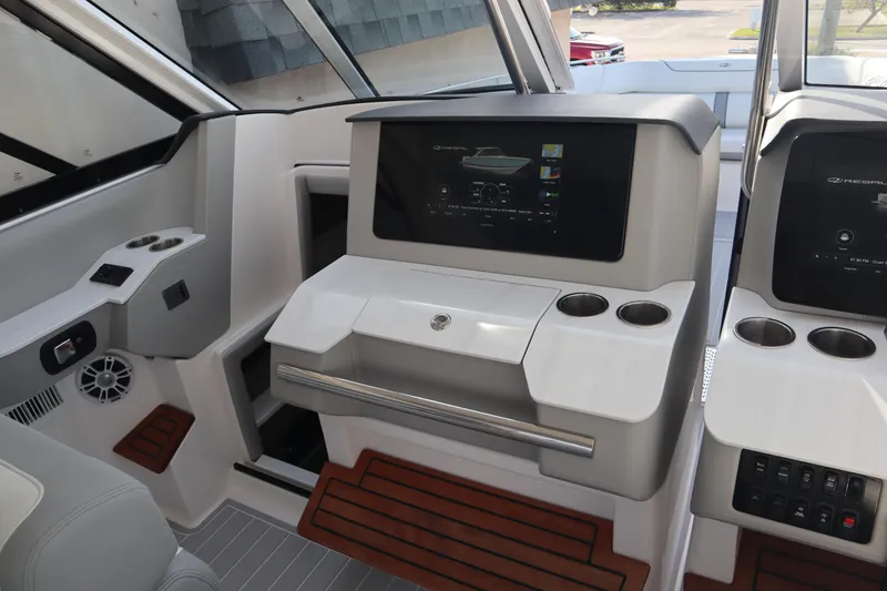 Slide: The Image of 2022 Regal LX36 boat interior with modern dashboard and wooden accents. - 40