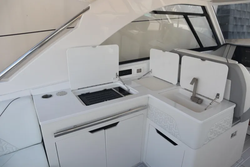 Slide: The Image of 2022 Regal LX36 yacht interior with sleek kitchen area, featuring sink and grill. - 48