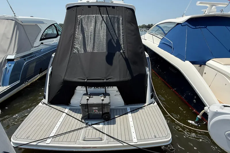 Slide: The Image of 2022 Formula 40 Performance Cruiser docked, rear view with black cover and Yeti cooler. - 21