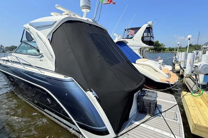 Slide: The Image of 2022 Formula 40 Performance Cruiser docked at marina, covered with black tarp. - 22