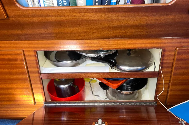 Slide: The Image of Wooden cabinet with cookware storage on a 1975 Contest 36 sailboat. - 10