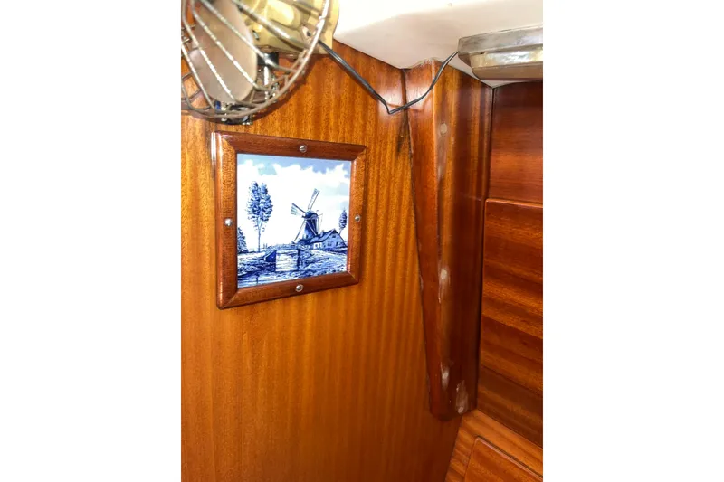 Slide: The Image of Wooden interior of a 1975 Contest 36 yacht with framed windmill artwork. - 13