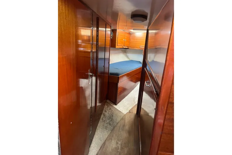 Slide: The Image of 1975 Contest 36 yacht interior with wooden finish and cozy sleeping area. - 18