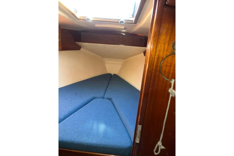 Slide: The Image of Cozy cabin interior of a 1975 Contest 36 sailboat with blue cushions. - 24