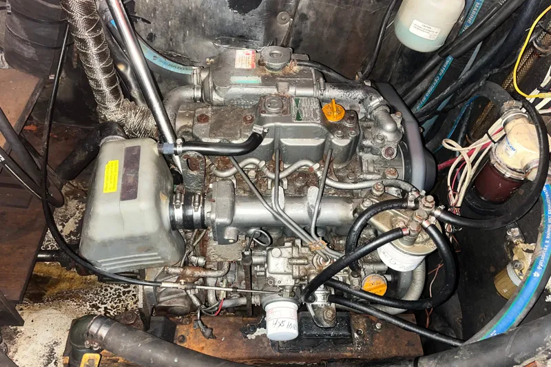Slide: The Image of Engine compartment of a 1975 Contest 36 sailboat, showcasing mechanical components and wiring. - 26