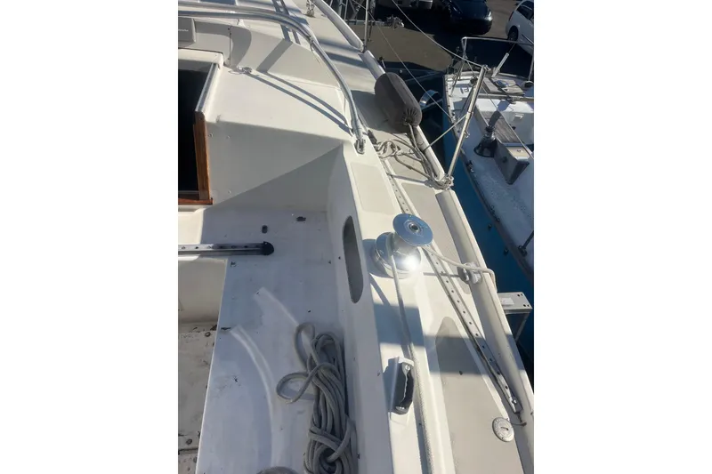 Slide: The Image of 1975 Contest 36 sailboat deck with winch and ropes in marina. - 4