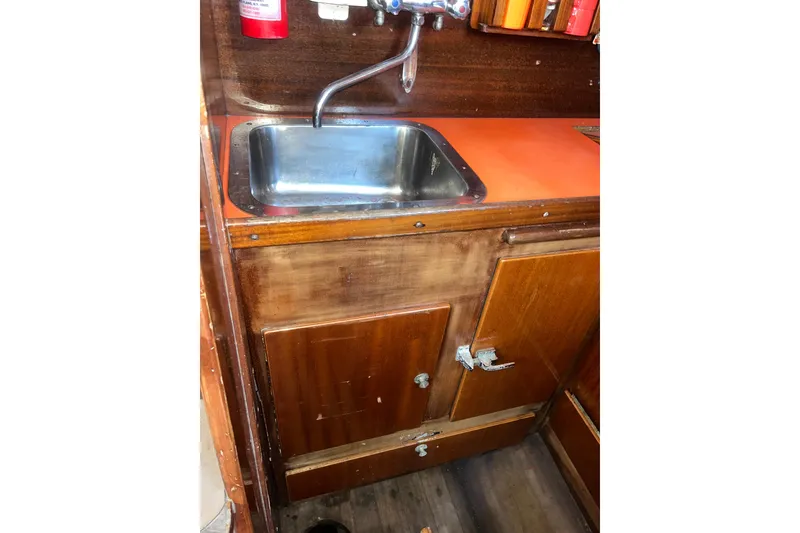 Slide: The Image of 1975 Contest 36 yacht interior with wooden cabinetry and stainless steel sink. - 8