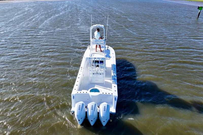 Slide: The Image of 2021 Onslow Bay 33 Tournament boat cruising on open water, aerial view. - 10