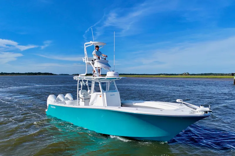 Slide: The Image of 2021 Onslow Bay 33 Tournament boat cruising on open water under clear blue sky. - 14