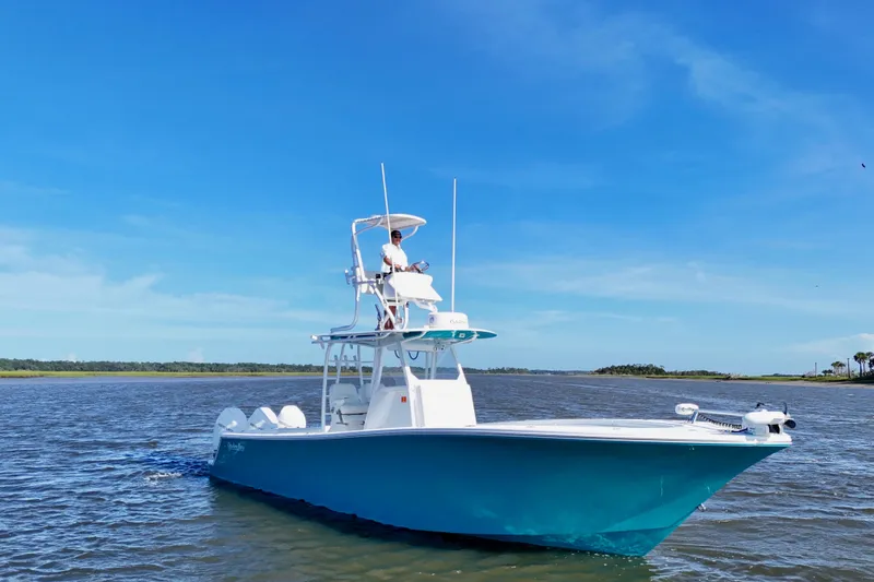 Slide: The Image of 2021 Onslow Bay 33 Tournament boat on calm water under clear blue sky. - 26