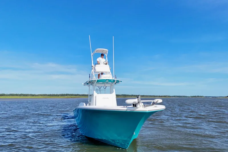 Slide: The Image of 2021 Onslow Bay 33 Tournament boat cruising on open water under clear blue sky. - 27
