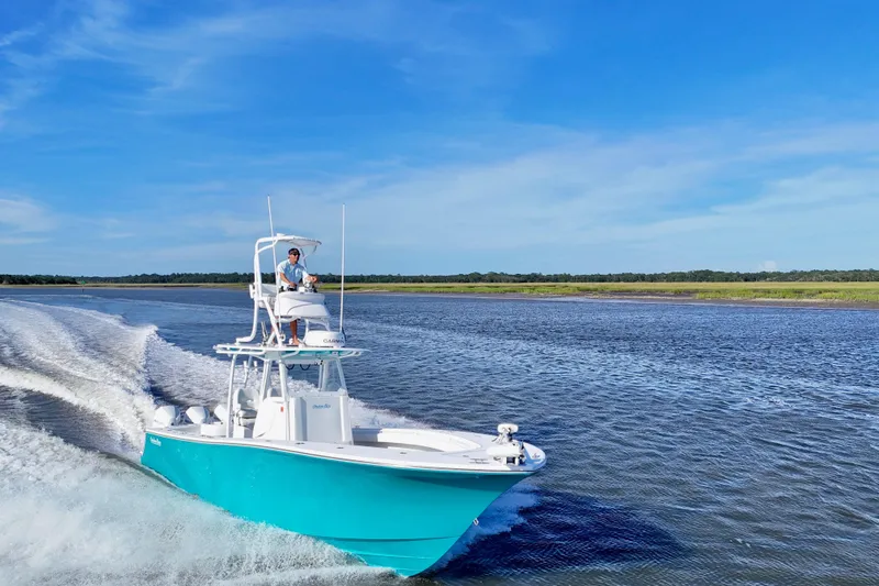 Slide: The Image of 2021 Onslow Bay 33 Tournament boat cruising on open water under clear blue sky. - 3