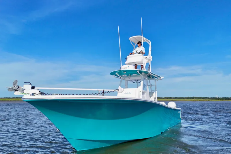 Slide: The Image of 2021 Onslow Bay 33 Tournament boat on water under clear blue sky. - 32