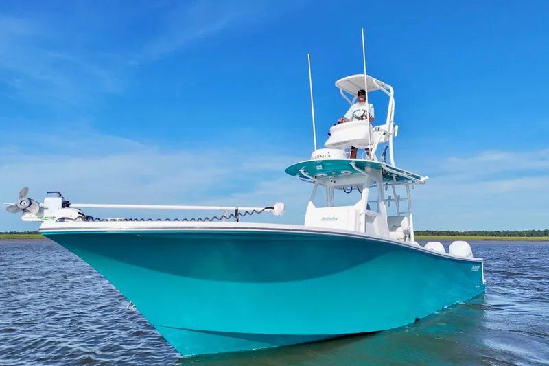 Slide: The Image of 2021 Onslow Bay 33 Tournament boat on water, clear blue sky background. - 33