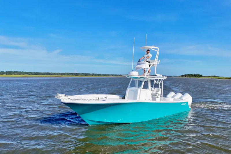 Slide: The Image of 2021 Onslow Bay 33 Tournament boat cruising on open water under clear blue sky. - 4