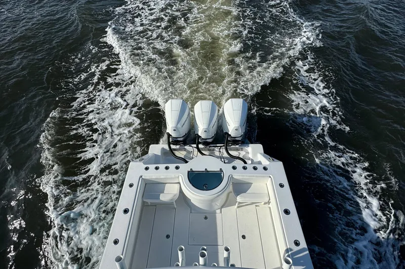 Slide: The Image of 2021 Onslow Bay 33 Tournament boat with triple engines cruising on water. - 41