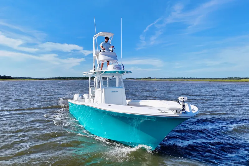 Slide: The Image of 2021 Onslow Bay 33 Tournament boat cruising on open water under clear blue skies. - 44