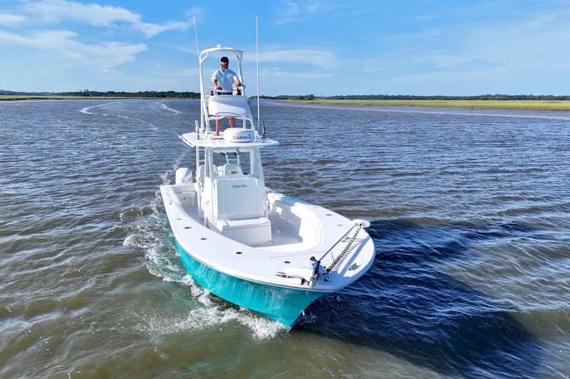 Slide: The Image of 2021 Onslow Bay 33 Tournament boat cruising on open water under clear blue skies. - 45