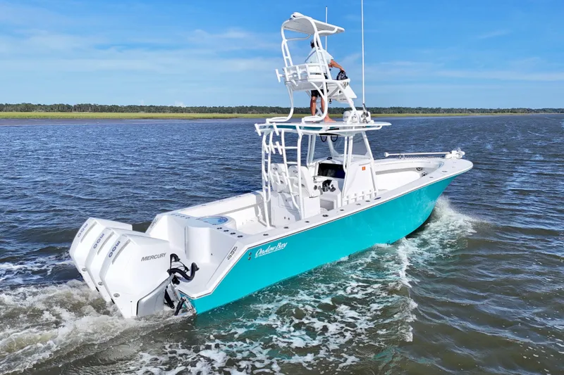 Slide: The Image of 2021 Onslow Bay 33 Tournament boat cruising on open water with twin Mercury engines. - 46