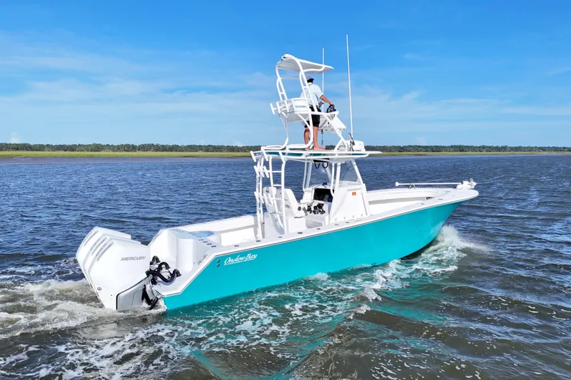 Slide: The Image of 2021 Onslow Bay 33 Tournament boat cruising on open water, featuring dual Mercury engines. - 49