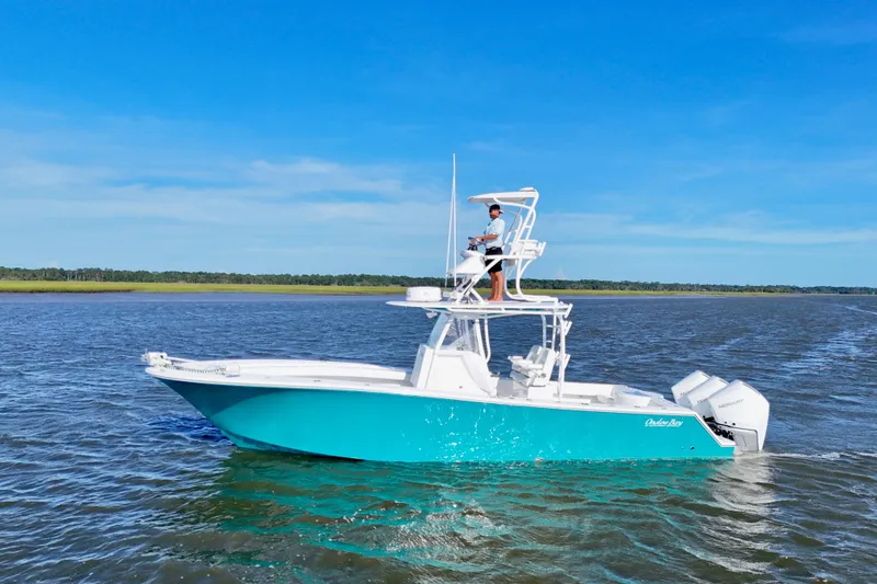 Slide: The Image of 2021 Onslow Bay 33 Tournament boat cruising on open water under clear blue sky. - 6