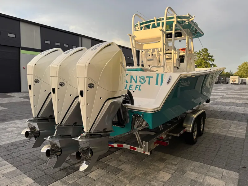 Slide: The Image of 2020 Onslow Bay 33 Tournament boat with triple engines on a trailer. - 61