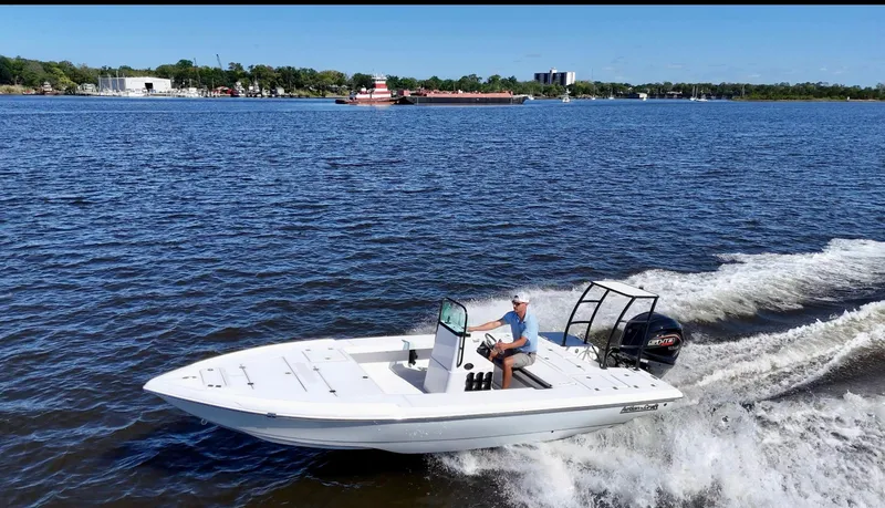 The Image of 2025 Action Craft 20 Flats boat cruising on a sunny day in open water. - 0