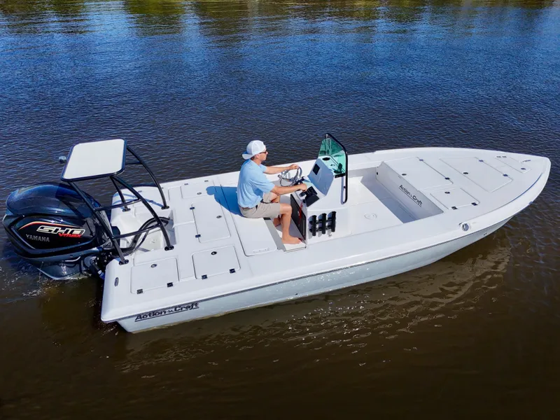 Slide: The Image of 2025 Action Craft 20 Flats boat on calm water, featuring a sleek design and powerful engine. - 13