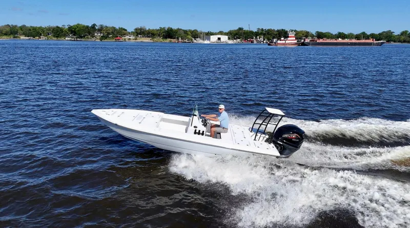 Slide: The Image of 2025 Action Craft 20 Flats boat cruising on a sunny day in open water. - 26