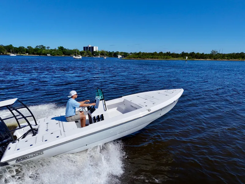 Slide: The Image of 2025 Action Craft 20 Flats boat cruising on a sunny day in open water. - 3