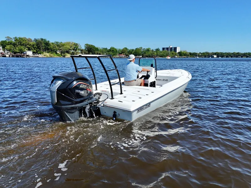 Slide: The Image of 2025 Action Craft 20 Flats boat cruising on a sunny day with Yamaha outboard motor. - 5