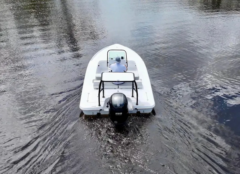 Slide: The Image of 2025 Action Craft 17 Flats boat cruising on calm water. - 14