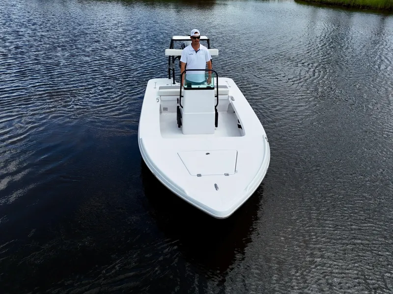 Slide: The Image of 2025 Action Craft 17 Flats boat on calm water, featuring a sleek design and modern features. - 15