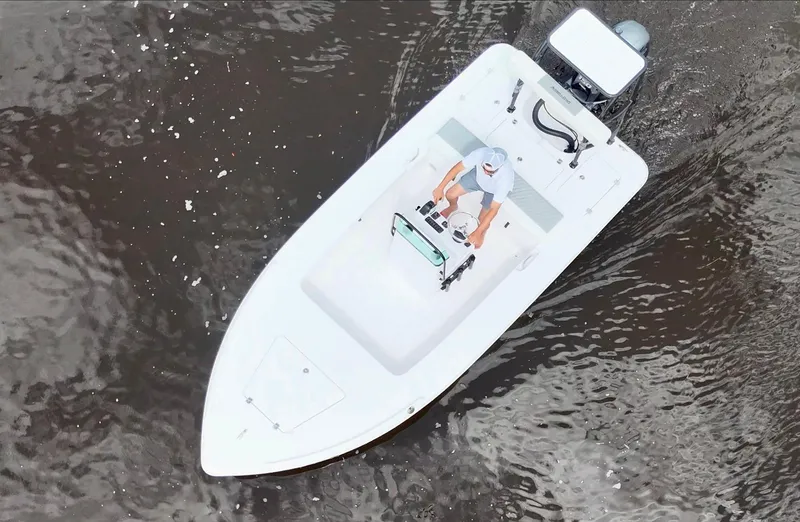 Slide: The Image of Overhead view of 2025 Action Craft 17 Flats boat navigating through water. - 25