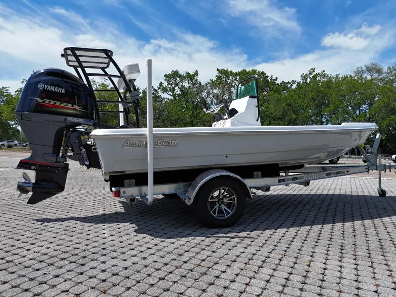 Slide: The Image of 2025 Action Craft 17 Flats boat on trailer, featuring Yamaha outboard motor, parked outdoors. - 29