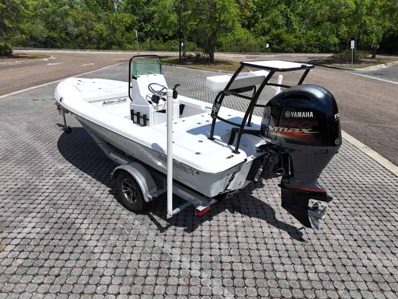 Slide: The Image of 2025 Action Craft 17 Flats boat with Yamaha engine on a trailer in a parking lot. - 30