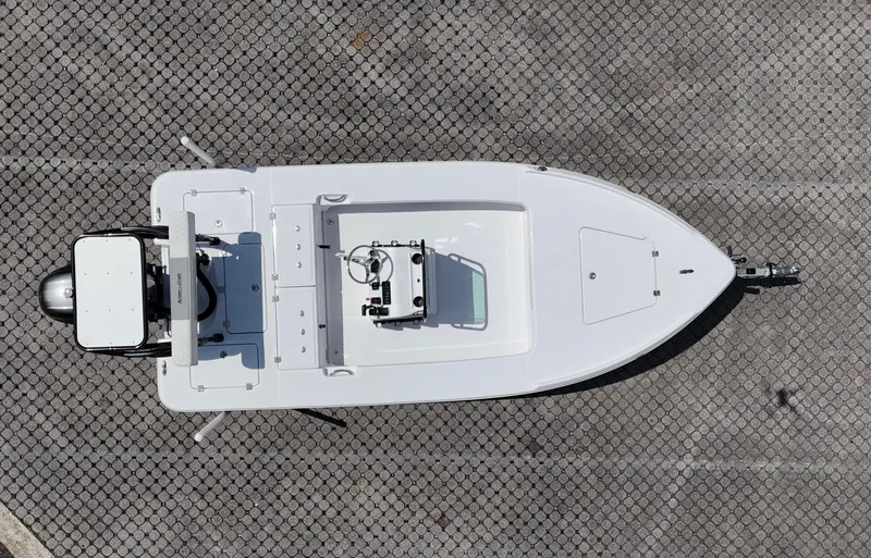 Slide: The Image of 2025 Action Craft 17 Flats boat, aerial view, parked on a patterned surface. - 55